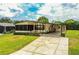 Inviting single-Gathering home featuring a well-manicured lawn and a spacious driveway, with ample parking at 1565 Heather Hill Dr, Lakeland, FL 33810