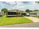 Charming single-story home with a long covered driveway and landscaped front yard at 1565 Heather Hill Dr, Lakeland, FL 33810