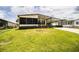 Single-story home with a covered driveway, screened windows, and green landscaped lawn at 1565 Heather Hill Dr, Lakeland, FL 33810