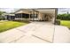 Charming tan single story home featuring a covered carport and landscaped front yard at 1565 Heather Hill Dr, Lakeland, FL 33810