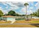 Community recreational center features a well maintained lawn bowling area, palm tree, and covered seating at 1565 Heather Hill Dr, Lakeland, FL 33810