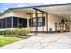 Charming home featuring a covered carport and front yard with lush landscaping at 1565 Heather Hill Dr, Lakeland, FL 33810