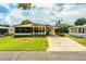 Attractive single-story home with a covered carport and lush green lawn at 1565 Heather Hill Dr, Lakeland, FL 33810