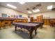 A view of the community's game room featuring two pool tables, a pool stick stand, and traditional decorations at 1565 Heather Hill Dr, Lakeland, FL 33810