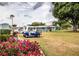 Community golf carts on display amid colorful flowers and manicured landscaping at 1565 Heather Hill Dr, Lakeland, FL 33810