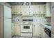 Bright kitchen with white cabinets, vintage appliances, and laminate countertops at 1565 Heather Hill Dr, Lakeland, FL 33810