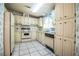 Bright kitchen with white cabinets, vintage appliances, and laminate countertops at 1565 Heather Hill Dr, Lakeland, FL 33810