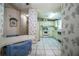 Eat-in kitchen with white appliances, patterned wallpaper, and tile floors offers a cozy space at 1565 Heather Hill Dr, Lakeland, FL 33810