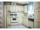 Bright kitchen with white cabinets, vintage appliances, and laminate countertops at 1565 Heather Hill Dr, Lakeland, FL 33810