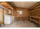 Spacious laundry area featuring a washer, dryer, storage cabinet and shelving at 1565 Heather Hill Dr, Lakeland, FL 33810