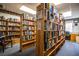 A view of the library featuring wooden shelves stocked with books, a chair, and a desk in the background at 1565 Heather Hill Dr, Lakeland, FL 33810