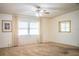 Bright living room showcasing neutral walls, large windows, and plush carpeting at 1565 Heather Hill Dr, Lakeland, FL 33810