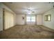 Large living room with neutral walls, plush carpeting, and abundant natural light, perfect for relaxation and gatherings at 1565 Heather Hill Dr, Lakeland, FL 33810
