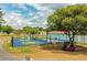 Active community featuring fenced pickleball courts, mature shade trees, and green space at 1565 Heather Hill Dr, Lakeland, FL 33810