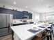 Gourmet kitchen with a large island, stainless steel appliances, and modern blue cabinetry at 1806 Teleford Rd, St Cloud, FL 34771