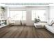 Bright living room with large windows, hardwood floors, and stylish modern furniture at 1806 Teleford Rd, St Cloud, FL 34771