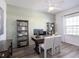 Well-lit office space with built-in shelving, a ceiling fan, and a large window at 1806 Teleford Rd, St Cloud, FL 34771