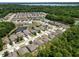 Expansive aerial view showcases a suburban neighborhood nestled amidst lush greenery and serene ponds at 1825 Wallace Manor Ln, Winter Haven, FL 33880
