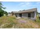 View of the backyard showing the lawn, patio, and fence at 1825 Wallace Manor Ln, Winter Haven, FL 33880