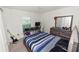 Bedroom with desk, computer, and bed near window at 1825 Wallace Manor Ln, Winter Haven, FL 33880