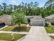 Charming single-story home featuring a well-manicured lawn, and a two-car garage at 1825 Wallace Manor Ln, Winter Haven, FL 33880