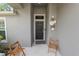 Inviting front porch with decorative door art and two cozy chairs for a welcoming entrance at 1825 Wallace Manor Ln, Winter Haven, FL 33880