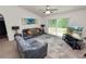 Cozy living room with natural light, ceiling fan, and sliding glass doors to the backyard at 1825 Wallace Manor Ln, Winter Haven, FL 33880
