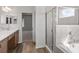 Bathroom featuring a shower, bath and wood cabinets at 2033 Summerlake Dr, Auburndale, FL 33823