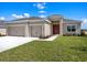 Charming single-story home with a two-car garage, neat landscaping, and a well-maintained lawn at 2033 Summerlake Dr, Auburndale, FL 33823