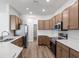 Modern kitchen featuring stainless appliances, light countertops and wood cabinets at 2033 Summerlake Dr, Auburndale, FL 33823