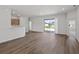Bright living room featuring neutral walls, wood-look flooring and glass sliding doors to the backyard at 2033 Summerlake Dr, Auburndale, FL 33823
