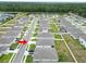 A neighborhood with sidewalks and pristine landscaping surrounds modern homes, showcasing a tranquil community setting at 2039 Rosewood Cir, Lakeland, FL 33810