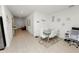 Contemporary dining area with a glass-top table and sleek, white chairs at 2039 Rosewood Cir, Lakeland, FL 33810