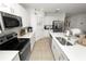 Modern kitchen featuring quartz countertops, stainless steel appliances, and center island sink at 2039 Rosewood Cir, Lakeland, FL 33810
