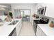 Well-lit kitchen with white cabinets, stainless steel appliances, and island seating at 2039 Rosewood Cir, Lakeland, FL 33810