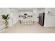 Open kitchen with white cabinets, stainless steel refrigerator, and large center island with chairs at 2039 Rosewood Cir, Lakeland, FL 33810