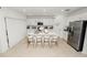 Bright kitchen with white cabinets, stainless appliances, island with seating, and tile flooring at 2039 Rosewood Cir, Lakeland, FL 33810