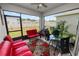 Enjoyable screened patio with outdoor seating, grill, and view of the backyard at 2039 Rosewood Cir, Lakeland, FL 33810