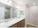 Modern bathroom with double sinks, marble countertop, vanity, and glass-enclosed shower at 2206 Oldham Ct, Haines City, FL 33844