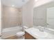 Bathroom featuring a shower-tub, toilet, sink with marble countertop, and framed mirror at 2206 Oldham Ct, Haines City, FL 33844