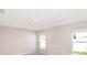 Bright bedroom with neutral walls, carpet floors, and windows allowing ample natural light at 2206 Oldham Ct, Haines City, FL 33844