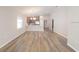 Open-concept living area with wood-look flooring, natural light, and modern fixtures, creating an inviting atmosphere at 2206 Oldham Ct, Haines City, FL 33844