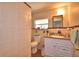 Well-lit bathroom featuring a vanity with granite countertops, tiled walls, and a modern toilet at 224 Raymond Ave, Frostproof, FL 33843