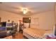 Bedroom featuring a ceiling fan, TV, desk, and comfortable bed setting at 224 Raymond Ave, Frostproof, FL 33843