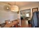 View of a dining area with a wooden table, chandelier, and an open doorway to the living room at 224 Raymond Ave, Frostproof, FL 33843