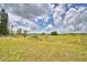 View of large lot with chain link fence and an open space, great for building a home at 224 Raymond Ave, Frostproof, FL 33843