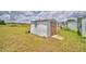 Backyard shed providing extra storage space in a grassy yard at 224 Raymond Ave, Frostproof, FL 33843