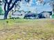 Backyard featuring mature trees, white picket fence, and the back of a cottage-style house with a screened-in porch at 236 E Seminole Ave, Lake Wales, FL 33853