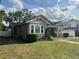View of home's exterior with charming architecture, a well-maintained lawn, and vibrant plants enhancing its curb appeal at 236 E Seminole Ave, Lake Wales, FL 33853