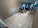 Tiled hallway with staircase, shelving, leading into another room with a TV, window, and doorway at 236 E Seminole Ave, Lake Wales, FL 33853